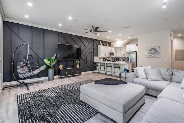 3210 W Horatio St Unit 9, Tampa, FL 33609 - living area featuring ornamental molding, light wood-type flooring, ceiling fan, recessed lighting, and a decorative wall