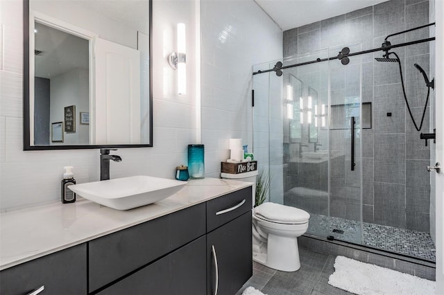 3210 W Horatio St Unit 9, Tampa, FL 33609 - bathroom with vanity, a stall shower, tile walls, and tile patterned flooring