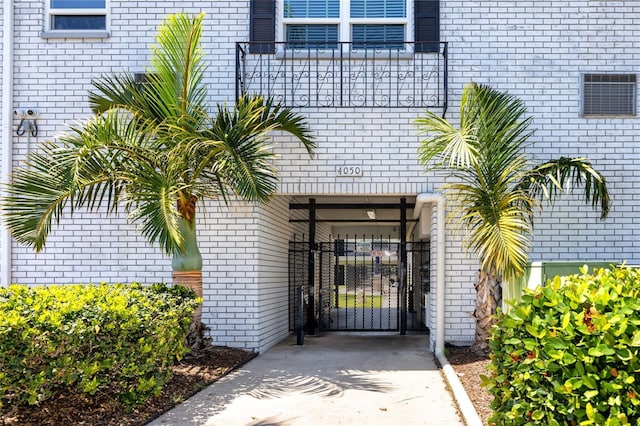 4050 4th St N Unit 116, Saint Petersburg, FL 33703 - property entrance with brick siding, driveway, and a gate