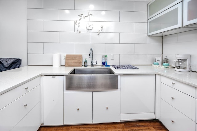 4050 4th St N Unit 116, Saint Petersburg, FL 33703 - kitchen with tasteful backsplash, white cabinetry, and glass insert cabinets
