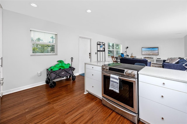 4050 4th St N Unit 116, Saint Petersburg, FL 33703 - kitchen with stainless steel electric range oven, light countertops, dark wood-style flooring, white cabinetry, and recessed lighting