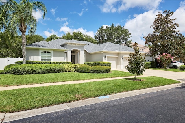 15412 Carrillon Estates Blvd, Tampa, FL 33625 - view of front of house with an attached garage, driveway, stucco siding, and roof with shingles