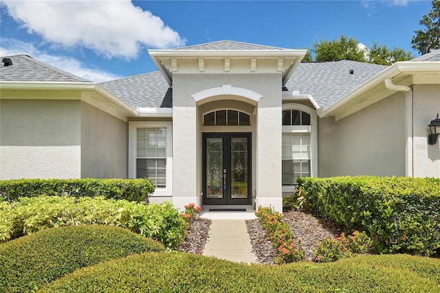 15412 Carrillon Estates Blvd, Tampa, FL 33625 - entrance to property featuring a shingled roof, french doors, and stucco siding