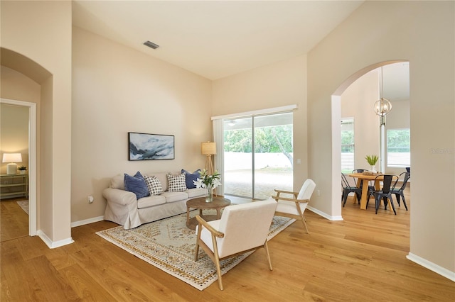 15412 Carrillon Estates Blvd, Tampa, FL 33625 - living room with arched walkways and light wood-style flooring