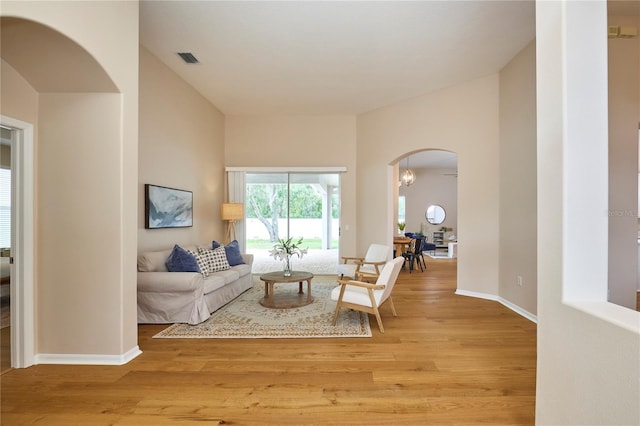 15412 Carrillon Estates Blvd, Tampa, FL 33625 - living room with arched walkways and light wood-style flooring