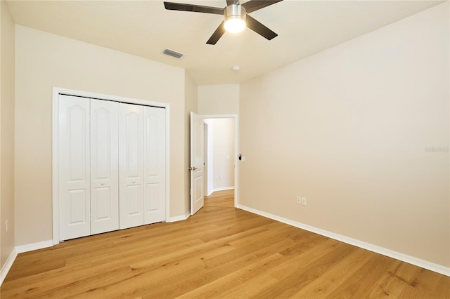 15412 Carrillon Estates Blvd, Tampa, FL 33625 - unfurnished bedroom with light wood-type flooring, a closet, and ceiling fan
