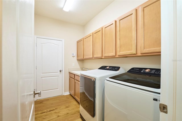 15412 Carrillon Estates Blvd, Tampa, FL 33625 - laundry room with washer and clothes dryer, light wood-type flooring, and cabinet space