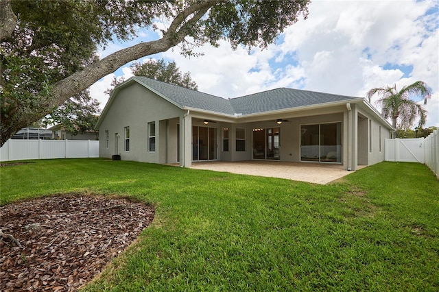 15412 Carrillon Estates Blvd, Tampa, FL 33625 - rear view of property featuring ceiling fan, a fenced backyard, a patio area, stucco siding, and a gate