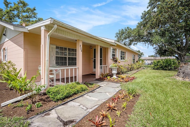 235 Old Welcome Rd, Lithia, FL 33547 - view of front facade with covered porch and a front lawn