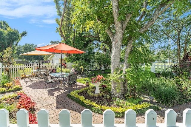 235 Old Welcome Rd, Lithia, FL 33547 - fenced backyard with outdoor dining area and a patio