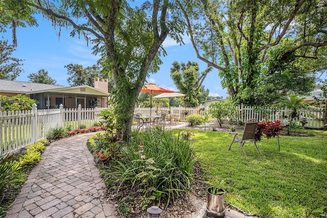 235 Old Welcome Rd, Lithia, FL 33547 - fenced backyard featuring a sunroom and a patio