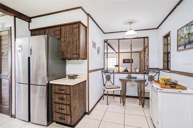 235 Old Welcome Rd, Lithia, FL 33547 - kitchen featuring freestanding refrigerator, ornamental molding, a textured ceiling, light countertops, and light tile patterned floors