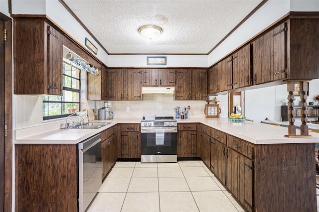 235 Old Welcome Rd, Lithia, FL 33547 - kitchen with stainless steel appliances, under cabinet range hood, a textured ceiling, a peninsula, and light countertops