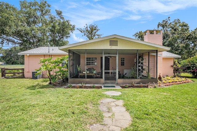 235 Old Welcome Rd, Lithia, FL 33547 - view of front facade with a sunroom, a chimney, and a front yard