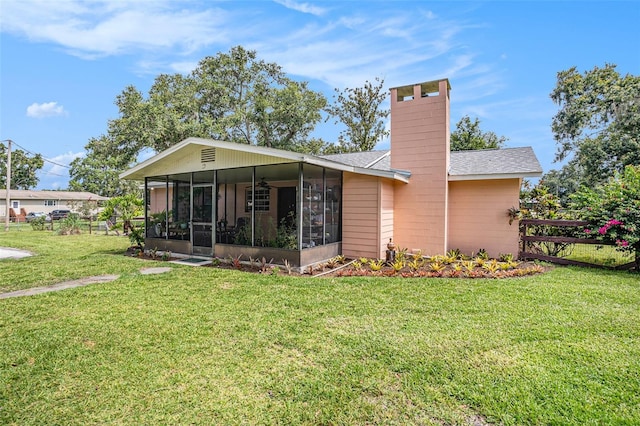 235 Old Welcome Rd, Lithia, FL 33547 - rear view of house featuring a sunroom, a chimney, a shingled roof, and ceiling fan