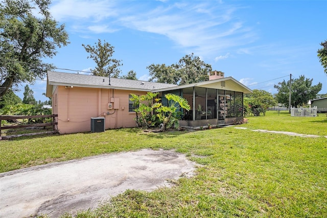 235 Old Welcome Rd, Lithia, FL 33547 - rear view of house featuring a sunroom and concrete block siding