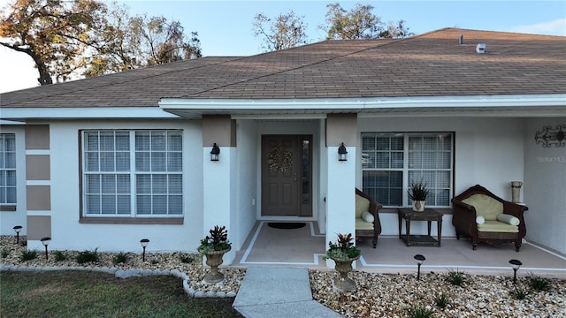 270 Planter Rd, Spring Hill, FL 34606 - doorway to property with roof with shingles, stucco siding, and covered porch