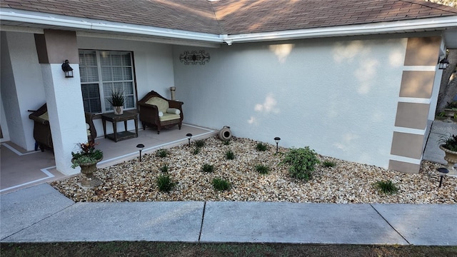 270 Planter Rd, Spring Hill, FL 34606 - view of property exterior with roof with shingles, stucco siding, and a porch