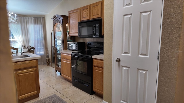 270 Planter Rd, Spring Hill, FL 34606 - kitchen with black appliances, light tile patterned floors, light countertops, and a textured wall