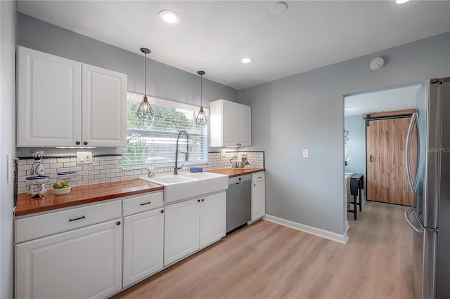 811 W Peninsular St, Tampa, FL 33603 - kitchen with appliances with stainless steel finishes, light wood-style flooring, tasteful backsplash, butcher block countertops, and recessed lighting