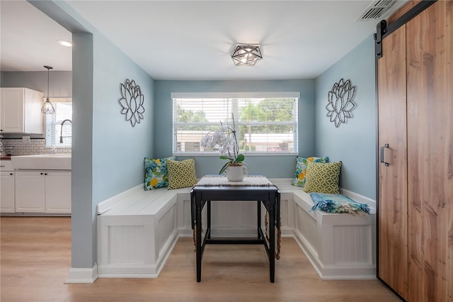 811 W Peninsular St, Tampa, FL 33603 - sitting room with light wood-style flooring, healthy amount of natural light, and a barn door
