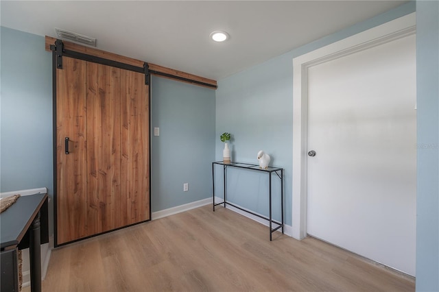 811 W Peninsular St, Tampa, FL 33603 - foyer entrance with a barn door and light wood-style flooring