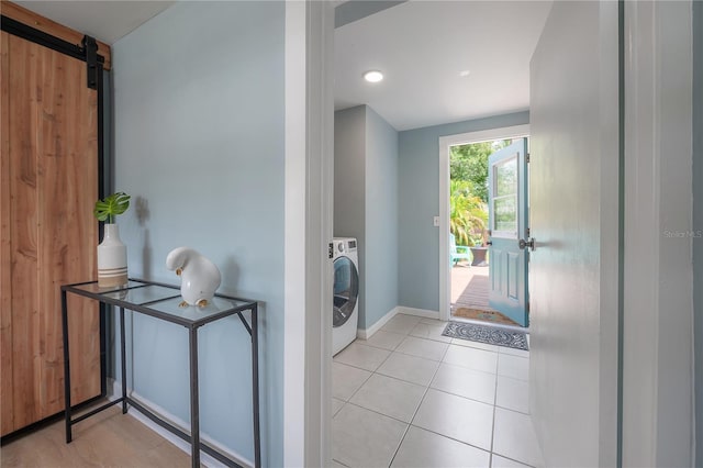 811 W Peninsular St, Tampa, FL 33603 - laundry area featuring washer / clothes dryer, light tile patterned floors, and a barn door