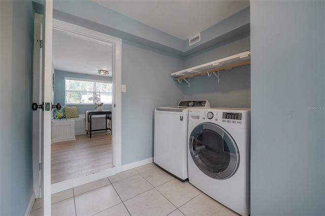 811 W Peninsular St, Tampa, FL 33603 - washroom with washing machine and clothes dryer and light tile patterned floors