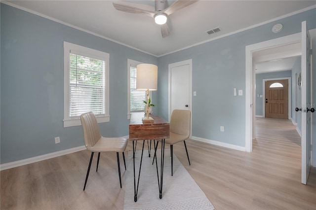811 W Peninsular St, Tampa, FL 33603 - dining room featuring ceiling fan, light wood finished floors, and ornamental molding