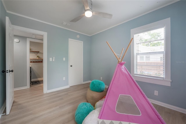 811 W Peninsular St, Tampa, FL 33603 - recreation room with light wood-type flooring, a ceiling fan, and ornamental molding