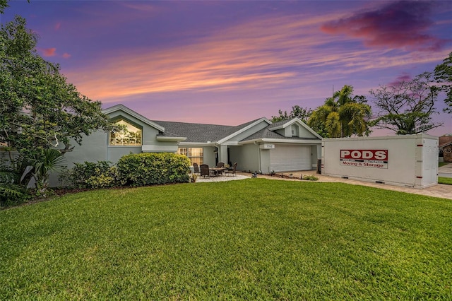 1763 Pebble Hill Ct, Palm Harbor, FL 34683 - view of front of house featuring a yard, an attached garage, driveway, and stucco siding
