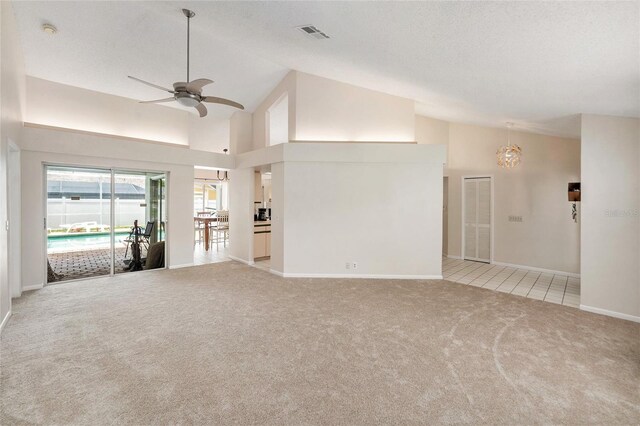 1763 Pebble Hill Ct, Palm Harbor, FL 34683 - unfurnished living room with light carpet, a ceiling fan, a chandelier, and high vaulted ceiling