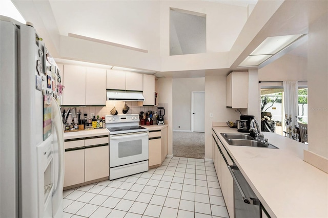 1763 Pebble Hill Ct, Palm Harbor, FL 34683 - kitchen with white appliances, range hood, light countertops, decorative backsplash, and light tile patterned floors