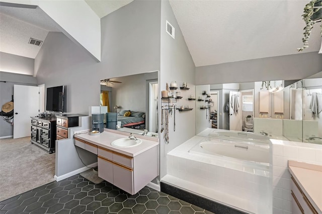 1763 Pebble Hill Ct, Palm Harbor, FL 34683 - bathroom with a garden tub, vanity, a textured ceiling, a ceiling fan, and tile patterned floors