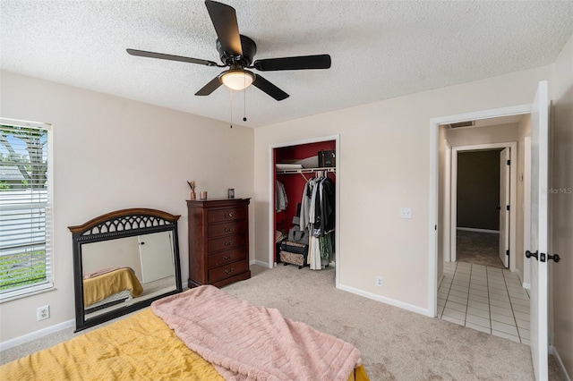 1763 Pebble Hill Ct, Palm Harbor, FL 34683 - bedroom featuring carpet, a closet, a textured ceiling, and a ceiling fan
