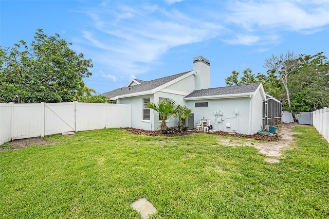 1763 Pebble Hill Ct, Palm Harbor, FL 34683 - back of house featuring stucco siding, a fenced backyard, a chimney, and roof with shingles