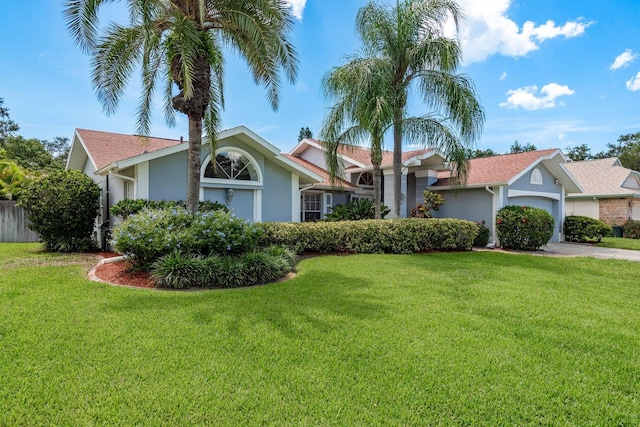 2800 Resnik Cir W, Palm Harbor, FL 34683 - view of front facade with stucco siding, a front lawn, and an attached garage