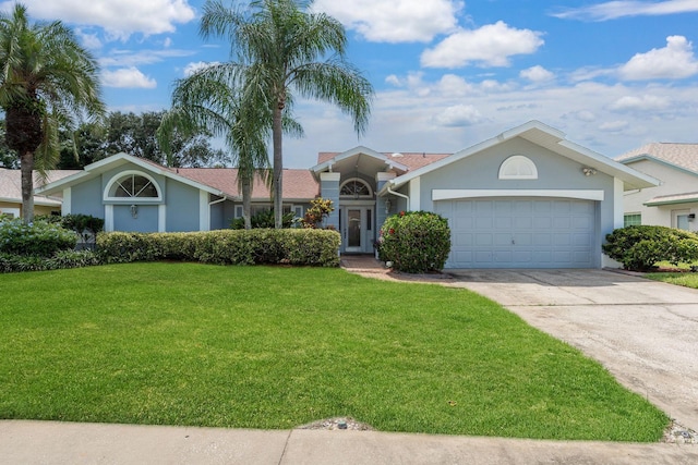 2800 Resnik Cir W, Palm Harbor, FL 34683 - view of front of property featuring concrete driveway, a front yard, an attached garage, and stucco siding