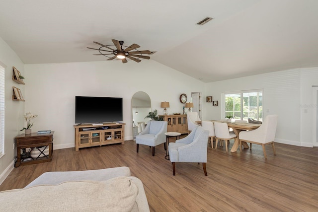 2800 Resnik Cir W, Palm Harbor, FL 34683 - living area with a ceiling fan, lofted ceiling, wood finished floors, and arched walkways