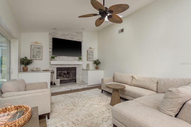 2800 Resnik Cir W, Palm Harbor, FL 34683 - living area with lofted ceiling, wood finished floors, a stone fireplace, and a ceiling fan