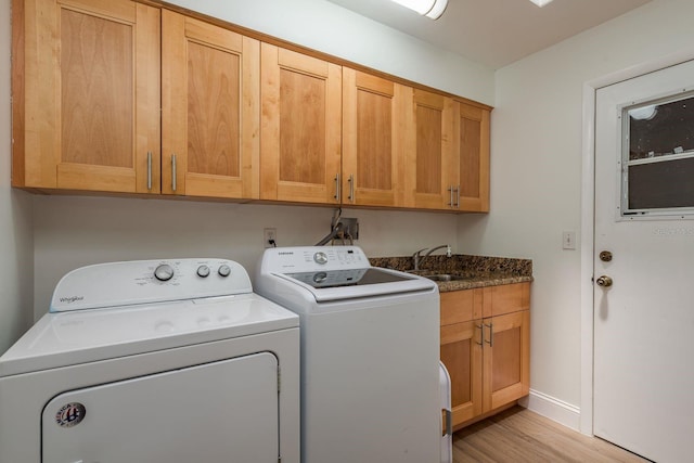 2800 Resnik Cir W, Palm Harbor, FL 34683 - laundry area with cabinet space, washing machine and clothes dryer, and light wood-type flooring