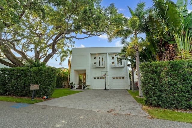 2711 W Trilby Ave, Tampa, FL 33611 - view of front of house featuring a garage and decorative driveway