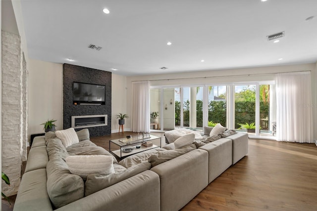 2711 W Trilby Ave, Tampa, FL 33611 - living area with a large fireplace, wood finished floors, and recessed lighting