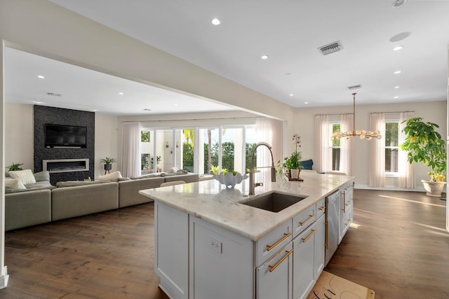 2711 W Trilby Ave, Tampa, FL 33611 - kitchen with recessed lighting, dark wood-style flooring, plenty of natural light, and light stone countertops