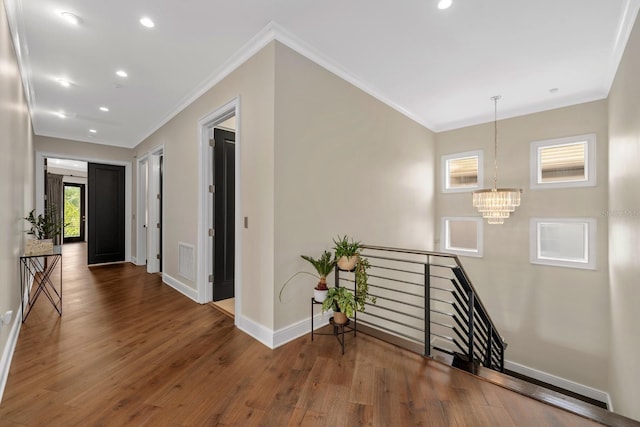 2711 W Trilby Ave, Tampa, FL 33611 - corridor featuring an upstairs landing, wood finished floors, crown molding, a chandelier, and recessed lighting