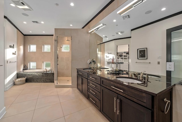 2711 W Trilby Ave, Tampa, FL 33611 - bathroom with a garden tub, double vanity, crown molding, a stall shower, and tile patterned flooring