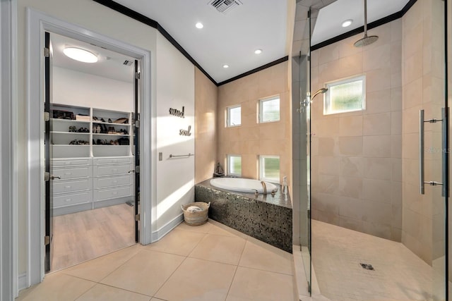 2711 W Trilby Ave, Tampa, FL 33611 - full bath with ornamental molding, a shower stall, a bath, a spacious closet, and tile patterned flooring
