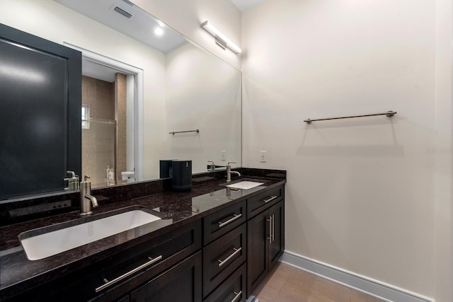 2711 W Trilby Ave, Tampa, FL 33611 - bathroom with double vanity and tile patterned flooring