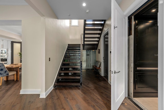 2711 W Trilby Ave, Tampa, FL 33611 - stairway featuring baseboards and hardwood / wood-style flooring