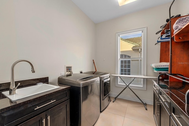 2711 W Trilby Ave, Tampa, FL 33611 - laundry area with separate washer and dryer, light tile patterned floors, and cabinet space